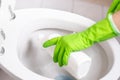 Hand of woman in green glove cleaning toilet Royalty Free Stock Photo