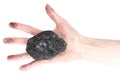 Hand of woman holding coal lump on white background Royalty Free Stock Photo