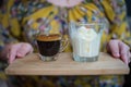 Hand of woman holding a cup of Affogato coffee or espresso with icecream on Wooden board Royalty Free Stock Photo