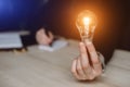 Hand of woman holding a light bulb for accounting and creative Royalty Free Stock Photo