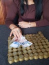 hand of a woman holding mexican banknotes and stacked coins of ten mexican pesos Royalty Free Stock Photo