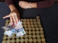 hand of a woman holding mexican banknotes and stacked coins of ten mexican pesos Royalty Free Stock Photo