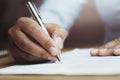 hand of woman holding pen with writing on paper report Royalty Free Stock Photo