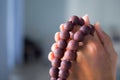 Hand woman holding rosary on blur background. Royalty Free Stock Photo