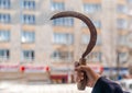 The hand of woman holding a sickle. Harvesting, respecting traditions