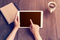 Hand woman holding tablet working on wood table in coffee shop with vintage filter. Royalty Free Stock Photo