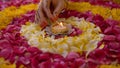 Hand of a woman lighting up a beautiful oil lamp placed in the center