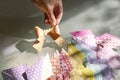 Hand woman makes origami from colored paper at the table