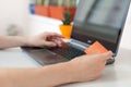 Hand of a woman making purchases through the Internet. Online Shopping. Focus on the hand and on the card Royalty Free Stock Photo