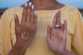 Hand of a woman meditating in a yoga pose on the beach at sunset Royalty Free Stock Photo