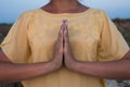 Hand of a woman meditating in a yoga pose on the beach at sunset Royalty Free Stock Photo