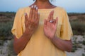 Hand of a woman meditating in a yoga pose on the beach at sunset Royalty Free Stock Photo