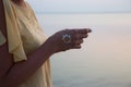 Hand of a woman meditating in a yoga pose on the beach at sunset Royalty Free Stock Photo