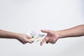 woman handing man several euro banknotes on a white background