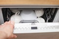 Hand of a woman open dishwasher with clean dishes in the kitchen Royalty Free Stock Photo