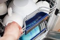 Hand of a woman open dishwasher with clean dishes in the kitchen Royalty Free Stock Photo