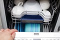 hand of a woman open dishwasher with clean dishes in the kitchen Royalty Free Stock Photo