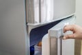 Hand a woman is opening refrigerator door Royalty Free Stock Photo