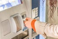 woman paying car parking time at automated terminal