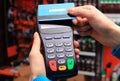 Hand of woman paying with contactless credit card, NFC technology Royalty Free Stock Photo