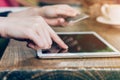 Hand woman pays by credit card for online purchase on a tablet