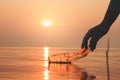 Hand Woman picking up empty of plastic bottle cleaning on the beach , volunteer concept. Environmental pollution.