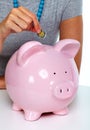 Hand of woman with piggy bank.