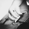 Hand of a woman playing acoustic guitar, black and white photography Royalty Free Stock Photo