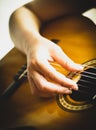 Hand of a woman playing acoustic guitar on a white background Royalty Free Stock Photo