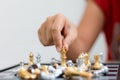 Hand of woman playing chess for business tactic and planning metaphor select focus shallow depth of field