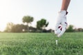 Hand woman putting a golf ball on the tee. Royalty Free Stock Photo