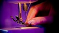 Hand of woman seamstress puts a thread in the eye of a needle Royalty Free Stock Photo