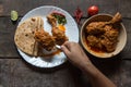 Hand of woman serving cooked food on a plate