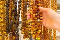 Hand of woman with shiny womanly amber necklaces on stall at the bazaar Royalty Free Stock Photo