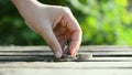 Hand of woman shorting coins over nature green leaf shallow depth of field