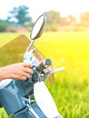 Hand of woman spraying alcohol nano mist sprayer on handlebar Motorcycle and face mask to prevent infection of Corona virusCovid- Royalty Free Stock Photo