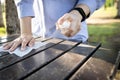 Hand of woman is spraying alcohol,wiping the dirt,disinfectant spray on table,during the pandemic of Covid-19,Coronavirus,cleaning