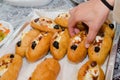 Hand woman takes a donut with eggs, olives and capsicum