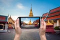 Hand woman taking photo at wat phratad haripunchai in lamphun