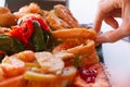 Hand of woman taking squid ring on traditional Spanish tapas Royalty Free Stock Photo