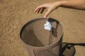 Hand of woman throwing waste in a trash can at Merida