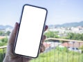 Hand of woman traveler using a mobile phone with while screen, traveling for summer vacation at the terrace Royalty Free Stock Photo