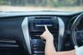 Hand of woman turning on car air condition system,Button on dashboard in car panel,Auto car air condition Car dashboard. Radio Royalty Free Stock Photo