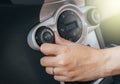 Hand of woman turning on car air conditioning system,Button on dashboard in car Royalty Free Stock Photo