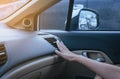 Hand of woman turning on car air conditioning system because to cold,Button on dashboard in car panel Royalty Free Stock Photo