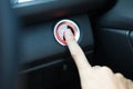 Hand of woman using finger for press start engine button with li