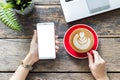 woman using a telephone, Blank screen smart phone and computer on wooden table top view. with clipping path Royalty Free Stock Photo