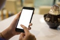 Hand woman using a telephone, empty screen smart phone and computer on wooden table with clipping path Royalty Free Stock Photo