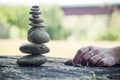 Hand of woman waiting for another stone for balance