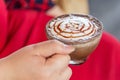 Hand women with cappuccino coffee blurred background Royalty Free Stock Photo